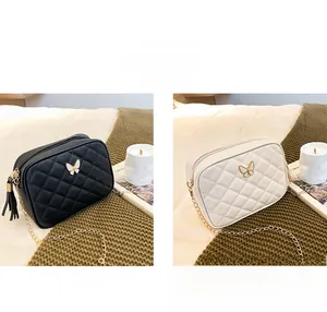 Quilted crossbody camera bags in black and white featuring butterfly clasps and tassels