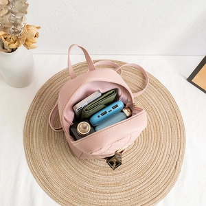 Pink quilted mini backpack showing spacious interior with phone and daily essentials