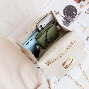 Beige straw chain handbag with interior view showing large storage capacity and metal lock