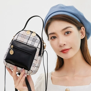 Mini plaid school backpack for women featuring stylish black leather front pocket and gold hardware