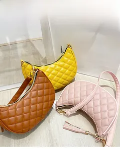 Detailed close-up of quilted crescent shoulder bags in yellow, tan, and pink with gold zippers