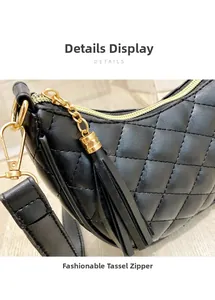 Close-up of black quilted shoulder bag featuring gold zipper and tassel detail
