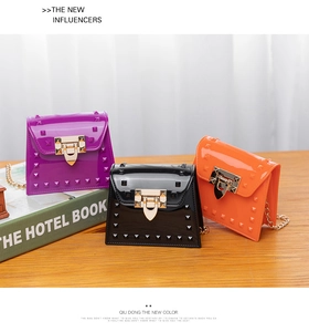 Detailed view of mini jelly crossbody bags with stud accents and golden chain straps