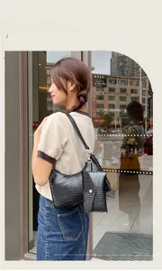 Black crocodile-pattern hobo bag with matching mini pouch and metal zipper detail