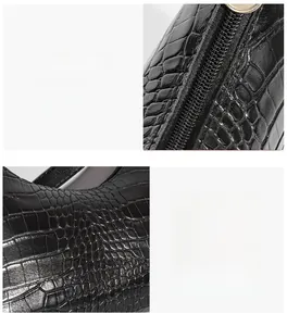 Detail view of black crocodile pattern faux leather with smooth zipper and stitching