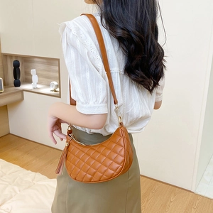 Brown quilted half-moon shoulder bag for women with adjustable strap and tassel detail