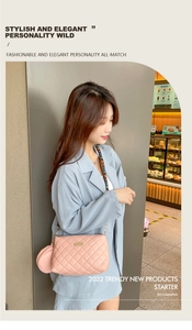 Pink quilted crossbody bag with rainbow strap and mini pouch shown on a model