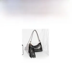 Detail of black crocodile embossed hobo bag with matching small coin purse attachment