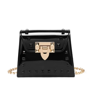 Fashionable black patent leather jelly bag with pyramid studs and gold chain strap
