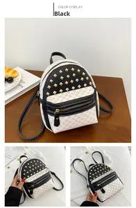 Detail of mini rivet backpack showing black leather contrast and gold pyramid studs