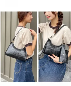 Detail of crocodile pattern shoulder bag with a matching small coin purse and gold hardware