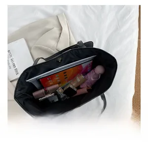 Internal view of the black tote bag showing large capacity for tablet and daily items