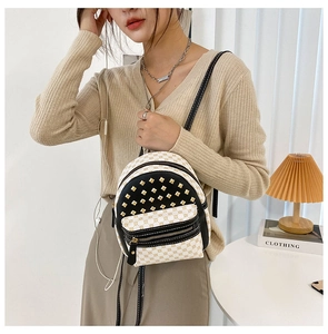 Detail of mini backpack featuring retro geometric prints and gold square rivets decor