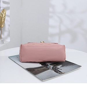 Flat base view of light pink quilted small square bag with fine stitching details