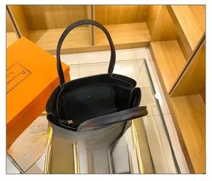 Detail view of large black tote bag interior with snap pocket and spacious compartment