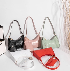 Detail of crocodile pattern underarm bags with matching mini pouches in five stylish colors