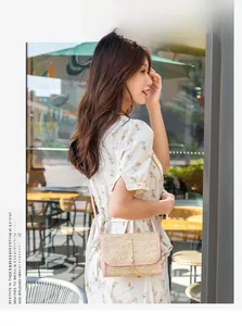 Close-up of pink leather trim and straw woven texture with a gold metal lock