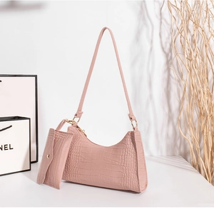 Detailed view of pink crocodile embossed hobo bag with matching coin purse and gold hardware