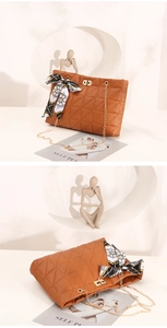 Détails d'un sac en cuir marron matelassé avec chaîne dorée et foulard en soie