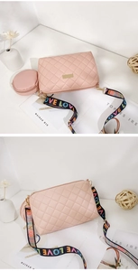 Detail of pink quilted crossbody bag with small coin purse and LOVE woven strap
