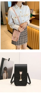 Close-up of vertical crossbody phone bag with V-quilted pattern and pearl cat ear charm