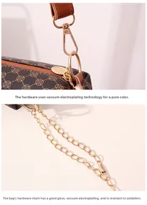 Detail of vacuum-plated gold hardware and clover pattern on brown shoulder bag