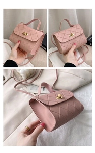 Detail of light pink quilted mini crossbody bag with metal twist lock and top handle