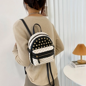 Mini backpack for women featuring rivet details and vintage monogram print on cream leather