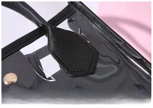 Close-up of precision stitching on transparent PVC handbag with black leather reinforcement