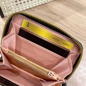 Pink minimalist accordion leather wallet with multiple card slots and gold zipper detail