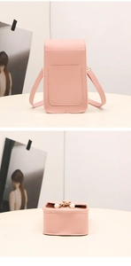 Detailed back view of pink phone bag with pearl charm and golden chain strap detail