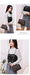 Chic coffee-brown crossbody bag with floral pattern and gold chain strap on a model