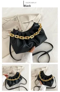 Detail of black pleated cloud bag with chunky gold chain and matte PU leather texture
