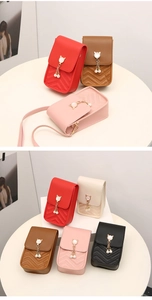 Close-up of quilted vertical phone bag with pearl charm and metallic cat ears detail