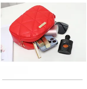 Macro view of red quilted PU shoulder bag showing internal capacity for daily essentials