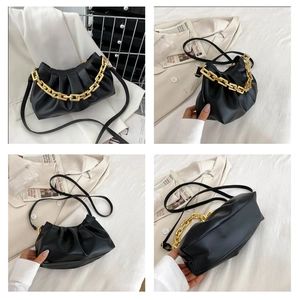 Detailed views of a black ruched cloud bag with chunky gold chain and leather strap
