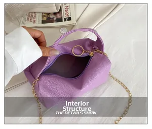 Detailed interior view of a purple lychee leather pillow bag with gold chain and zipper