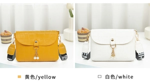 Detail of yellow and white croc-embossed mini bags with pearl tassels and wide straps