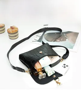Detail view of mini crocodile pattern crossbody bag showing internal storage capacity
