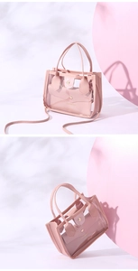 Detail of pink transparent PVC tote bag with inner leather pouch and gold embossing