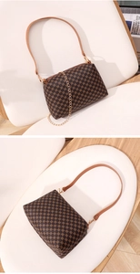 Detail of small crossbody bag with geometric pattern, gold chain, and thin leather strap