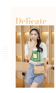 Detail of elegant beige quilted crossbody bag featuring metal chain and top handle