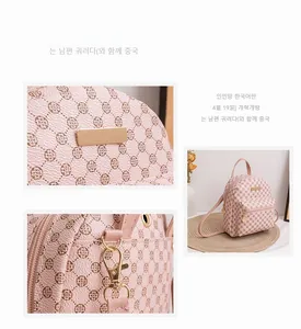 Detailed close-up of pink backpack with clover pattern and gold metal hardware accents