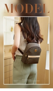 Detail of a brown geometric print mini backpack with golden metal logo and dual zippers