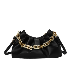 Minimalist black pleated cloud bag with thick gold chain and adjustable shoulder strap