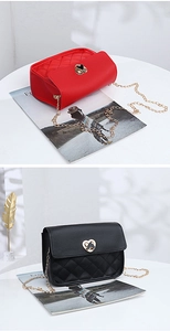Detail of small quilted square bags with golden heart-shaped locks and chain straps