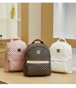 Macro detail of three multi-color mini backpacks with vintage geometric circle prints