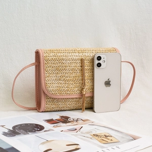 Mini straw shoulder bag with pink faux leather trim and golden tassel detail