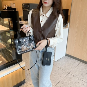 Minimalist clear PVC tote bag with black faux leather trim and matching inner pouch