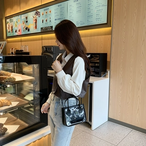 Mini clear PVC and black leather tote bag with shoulder strap and inner pouch